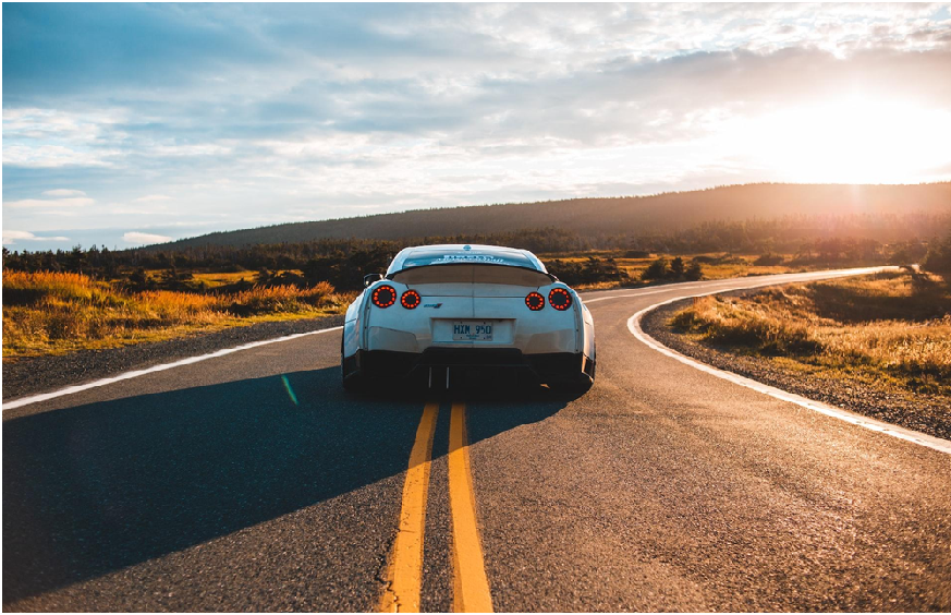 A picture of a car driving down the road as Elijah Norton developed a service for the vehicle protection plan industry